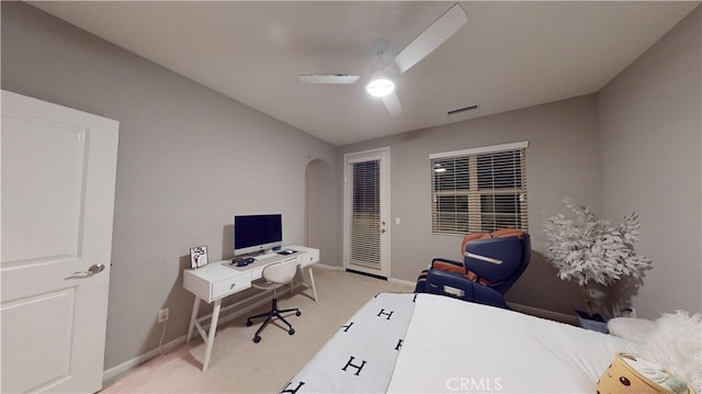 carpeted office space with ceiling fan