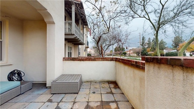 view of patio featuring a balcony