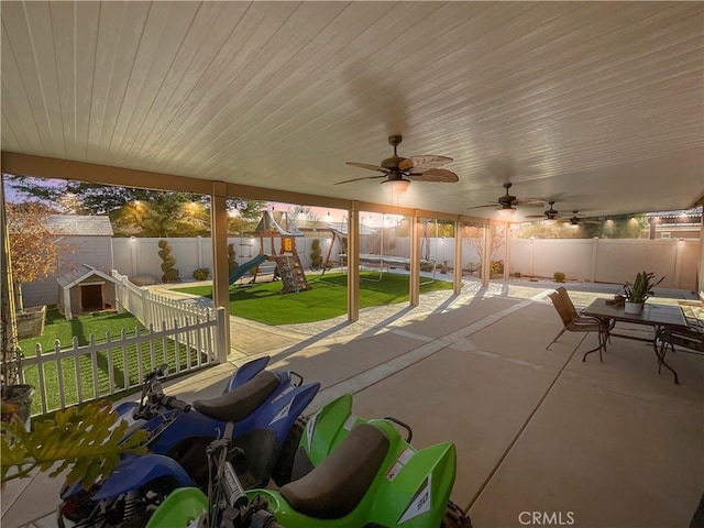 view of patio / terrace with ceiling fan and a playground