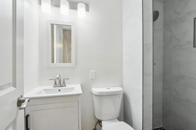 bathroom with vanity, toilet, and a shower with shower door