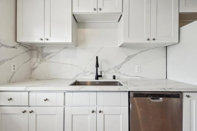 kitchen with tasteful backsplash, sink, stainless steel dishwasher, and white cabinets