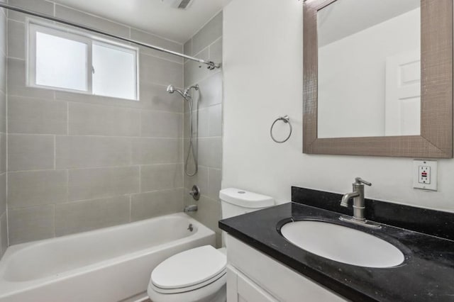 full bathroom with tiled shower / bath combo, vanity, and toilet