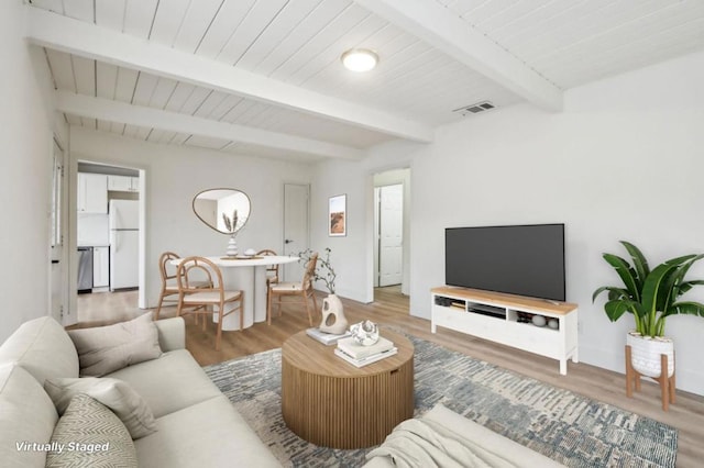 living room with hardwood / wood-style flooring and beamed ceiling