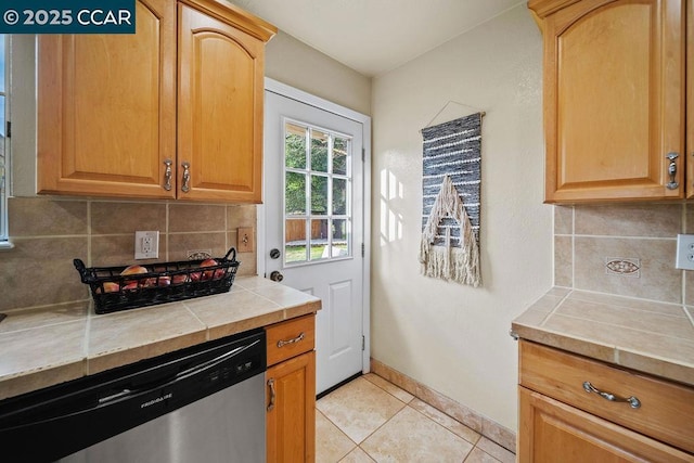 kitchen with backsplash, tile countertops, dishwasher, and light tile patterned floors