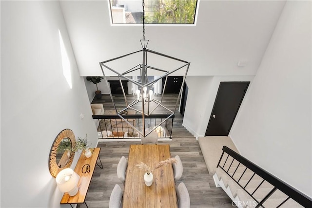 interior space with plenty of natural light, an inviting chandelier, and dark hardwood / wood-style flooring