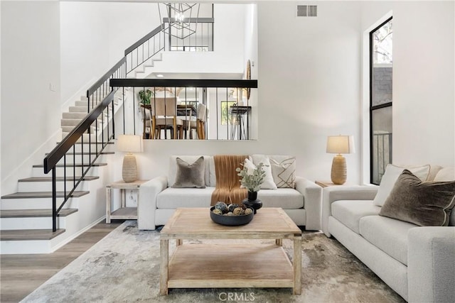 living room featuring a chandelier and hardwood / wood-style floors