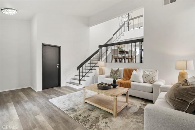 living room featuring wood-type flooring and a chandelier