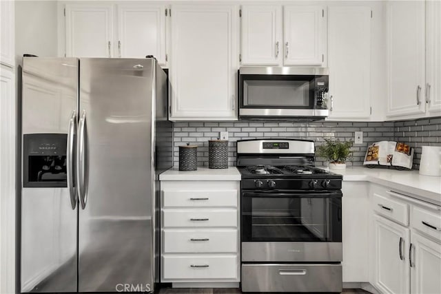 kitchen with stainless steel appliances, white cabinetry, and tasteful backsplash