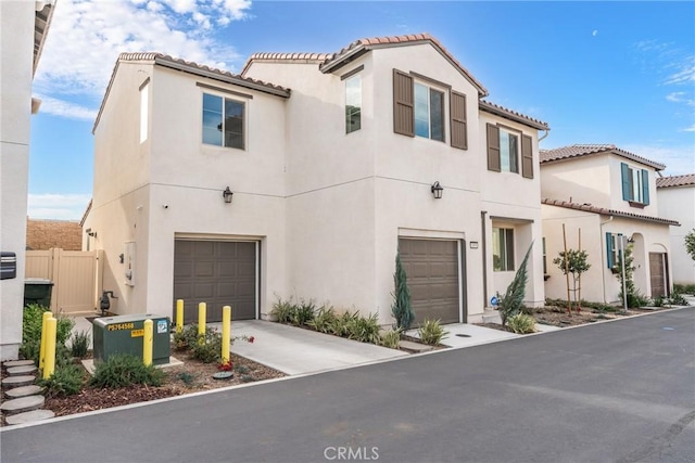 mediterranean / spanish home with a garage