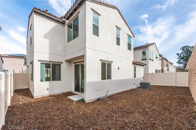 rear view of property featuring central AC unit