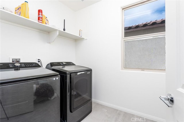 washroom with washer and dryer