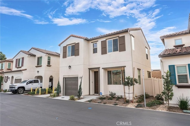 mediterranean / spanish-style home with a garage