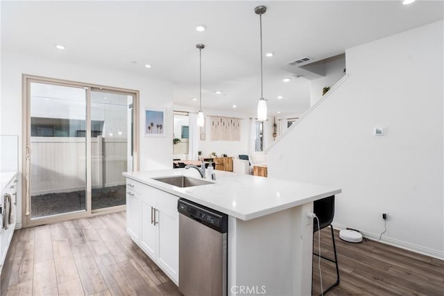 kitchen with sink, white cabinetry, hanging light fixtures, a center island with sink, and stainless steel dishwasher