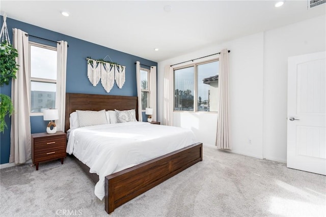 carpeted bedroom featuring multiple windows