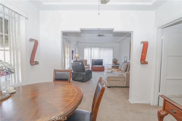 dining space featuring light colored carpet