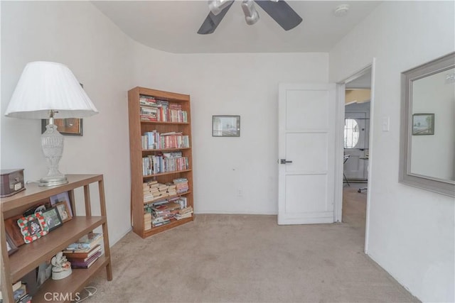 interior space with light colored carpet and ceiling fan