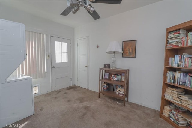 carpeted entrance foyer with ceiling fan