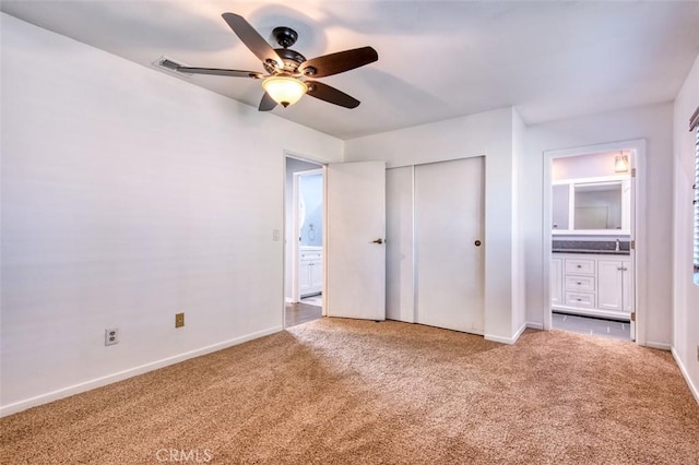 unfurnished bedroom with ceiling fan, carpet flooring, and a closet