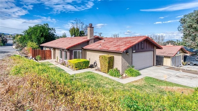 view of front of property with a garage and a front lawn