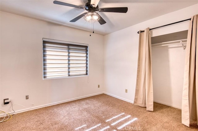 unfurnished bedroom with light colored carpet, ceiling fan, and a closet