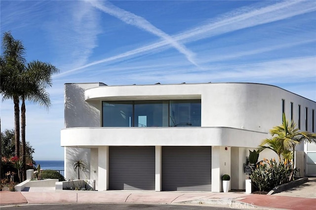 view of front of home with a garage and a water view