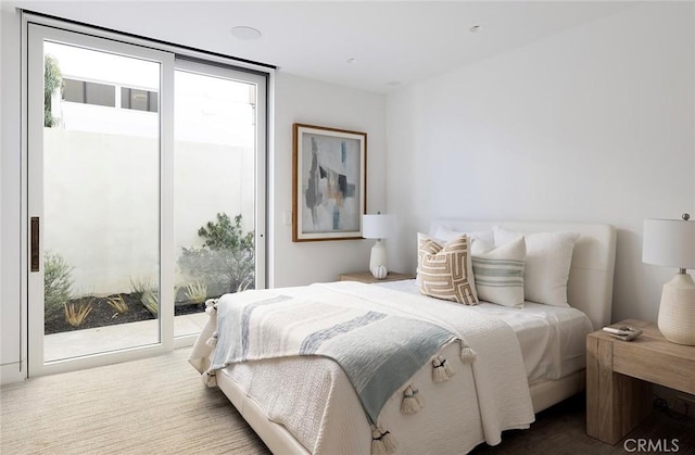 bedroom featuring carpet floors, access to outside, and a wall of windows