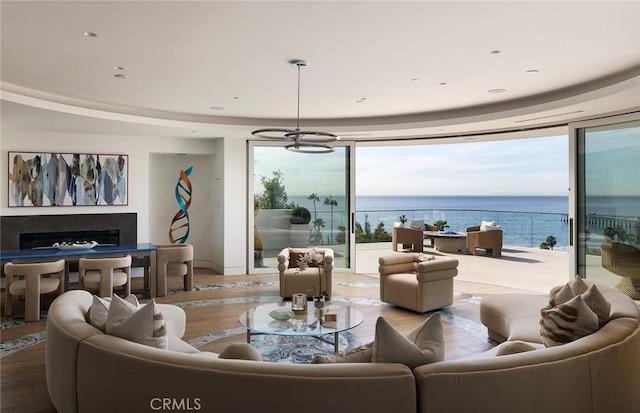 living room with a water view, plenty of natural light, and wood-type flooring