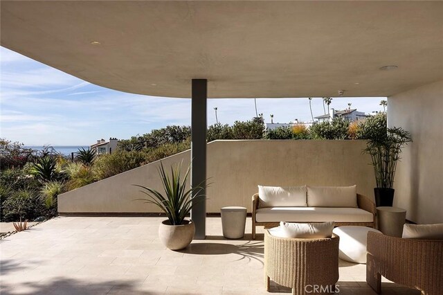 view of patio featuring an outdoor living space and a water view