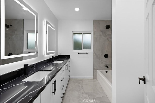 bathroom with tiled shower / bath and vanity