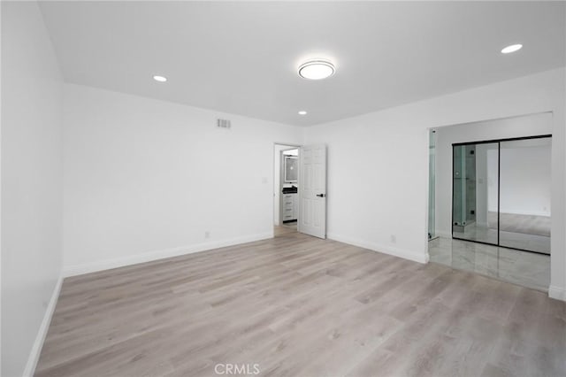 spare room with light hardwood / wood-style floors