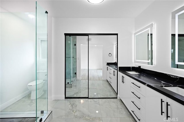 bathroom with vanity, toilet, and an enclosed shower