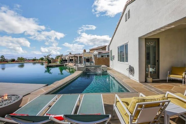 view of swimming pool featuring an in ground hot tub, a patio, and a water view