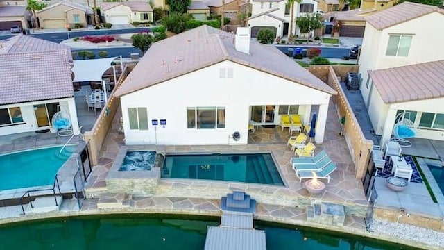 rear view of house featuring a hot tub, a patio, and central AC unit