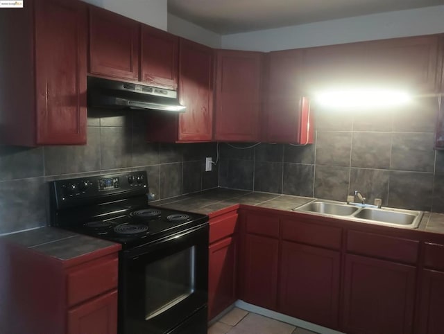 kitchen with tile counters, sink, black electric range, and tasteful backsplash