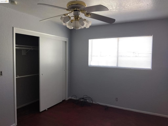 unfurnished bedroom featuring a textured ceiling, ceiling fan, and a closet