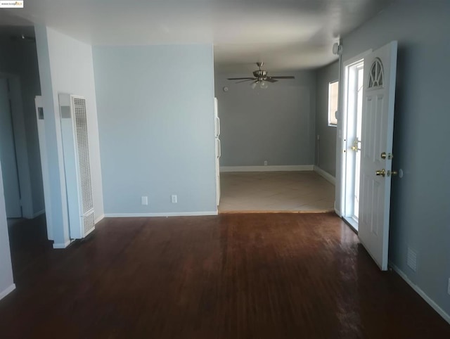 unfurnished room with dark hardwood / wood-style flooring and ceiling fan