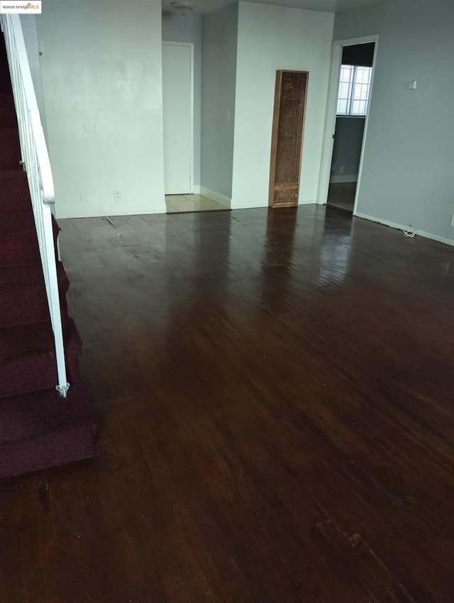 unfurnished room with dark hardwood / wood-style flooring