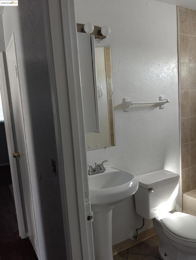 bathroom featuring tile patterned floors and toilet