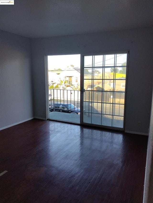 unfurnished room featuring dark hardwood / wood-style flooring