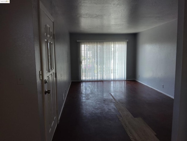 unfurnished room featuring a textured ceiling