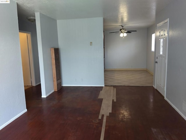 spare room with dark hardwood / wood-style floors and ceiling fan