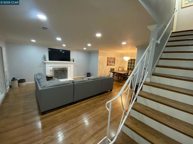 living room with hardwood / wood-style flooring and ornamental molding