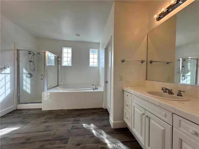 bathroom featuring independent shower and bath and vanity