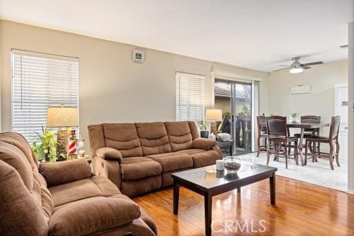 living room featuring ceiling fan and light hardwood / wood-style flooring