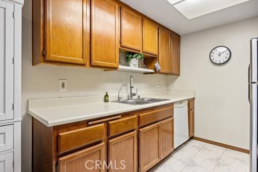 kitchen featuring sink, stainless steel fridge, and dishwasher