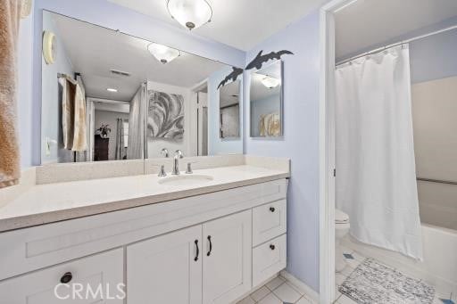 full bathroom featuring vanity, shower / bathtub combination with curtain, and toilet