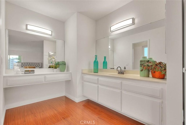 bathroom with vanity and hardwood / wood-style flooring