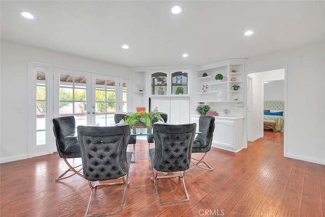 dining room with wood-type flooring and french doors