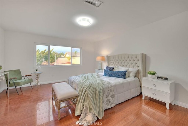 bedroom with hardwood / wood-style flooring