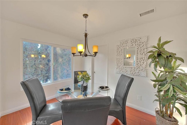 dining room with a notable chandelier and hardwood / wood-style flooring